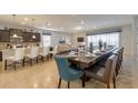 Open-concept dining area with spacious table, modern lighting, and seamless flow to the kitchen at 1876 Nice Ct, Kissimmee, FL 34747