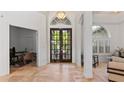 Bright foyer features double doors, arched windows, and neutral-toned tile flooring at 2218 Ridgewind Way, Windermere, FL 34786