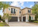 Elegant two-story home with a brick driveway, two-car garage, balcony, and manicured landscaping at 3144 Players View Cir, Longwood, FL 32779