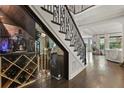 Elegant interior featuring a temperature controlled wine cellar, hardwood floors, and a decorative iron staircase at 3144 Players View Cir, Longwood, FL 32779