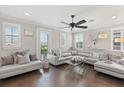 Modern living room featuring a plush sectional sofa, hardwood floors, and plenty of natural light at 3144 Players View Cir, Longwood, FL 32779