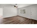 Bright living room with laminate flooring, a ceiling fan, and a window at 33830 S Haines Creek Rd, Leesburg, FL 34788
