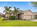 Inviting exterior of the home showcasing a well-kept lawn and a brick driveway at 3936 Parkhouse Dr, Orlando, FL 32824