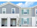 Well-maintained townhome exterior with attractive gray siding, white trim, and a cozy entrance at 3966 Lana Ave, Davenport, FL 33897