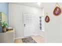 Inviting foyer with decorative accents, built-in shelving, and neutral flooring at 3966 Lana Ave, Davenport, FL 33897