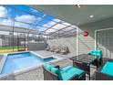 Relaxing screened-in pool area featuring comfortable lounge chairs and a stylish outdoor setting at 3966 Lana Ave, Davenport, FL 33897