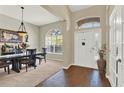 Elegant entryway boasting hardwood floors, arched transom windows, and a view into the dining room at 408 Almeria Ct, Winter Springs, FL 32708