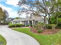Well-maintained one-story house featuring lush lawn, mature trees, and a curved driveway at 408 Almeria Ct, Winter Springs, FL 32708