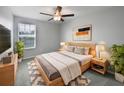 Cozy bedroom featuring a ceiling fan, natural light, and a comfortable queen bed at 4346 Trotters Way, Lakeland, FL 33801