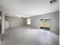 Spacious, bright living area featuring tile flooring and sliding glass doors to the backyard at 4346 Trotters Way, Lakeland, FL 33801