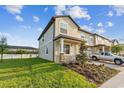 A well-maintained townhouse boasts a lush lawn and a brick-paved driveway leading to the garage at 4461 Summer Flowers Pl, Kissimmee, FL 34746