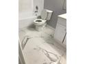 The bathroom features a toilet, tub, and vanity with a marble pattern tile floor at 480 Banyon Tree Cir # 100, Maitland, FL 32751