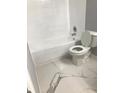 The bathroom features a toilet, tub, and marble pattern tile floor at 480 Banyon Tree Cir # 100, Maitland, FL 32751