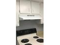 The kitchen features white cabinets and appliances at 480 Banyon Tree Cir # 100, Maitland, FL 32751