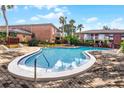 Beautifully maintained community pool featuring brick pavers, lounge chairs, and a relaxing atmosphere at 480 Banyon Tree Cir # 100, Maitland, FL 32751