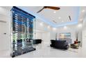 Open-concept living area with modern wine storage, marble floors, and seamless transitions to other rooms at 49 Interlaken Rd, Orlando, FL 32804