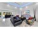 Bright living room featuring recessed lighting, modern furnishings, and a view to the front yard at 49 Interlaken Rd, Orlando, FL 32804
