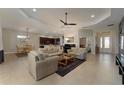 Open-concept living room featuring tile flooring, neutral paint, recessed lighting, and comfortable seating at 5007 Belted Kingfisher Dr, Oxford, FL 34484