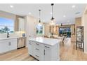 Modern kitchen with a central island, stainless steel appliances, and ample counter space at 5166 Gardenrow Dr, St Cloud, FL 34772