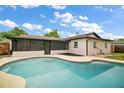 Inviting swimming pool with a screened lanai and a spacious backyard, perfect for outdoor entertaining at 5334 Mary Ann Ln, Orlando, FL 32810