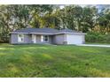 Charming single-story home with a well-manicured lawn and attached two car garage at 57 Pine Trace Crse, Ocala, FL 34472