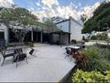 Exterior patio with a pergola, outdoor seating, and lush landscaping for a relaxing outdoor space at 6165 Carrier Dr # 3104, Orlando, FL 32819