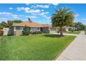 Attractive home with a lush green lawn, lovely landscaping, and an American flag at 743 Lake Douglas Dr, Groveland, FL 34736