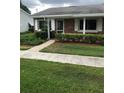 Quaint brick home with a well-maintained lawn and sidewalk at 769 Avenue Q Se, Winter Haven, FL 33880