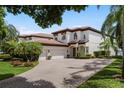 Lovely home showcasing a brick driveway, lush landscaping, and a tile roof at 8161 Via Rosa, Orlando, FL 32836