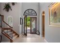Grand foyer featuring high ceilings, decorative glass door, and staircase at 8161 Via Rosa, Orlando, FL 32836