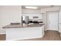 Bright kitchen featuring white cabinets, stainless steel appliances, and a breakfast bar at 911 N Orange Ave # 541, Orlando, FL 32801