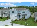Beautiful two-story home with manicured lawn, landscaping, and an attached two car garage at 9763 Brown Burrow St, Orlando, FL 32829