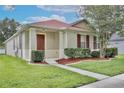 Charming single-story home with a well-manicured lawn and inviting front porch at 14717 Royal Poinciana Dr, Orlando, FL 32828
