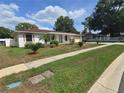 A charming single-story home with a well-maintained lawn and mature trees on a sunny day at 217 Longleaf Ct, Orlando, FL 32835