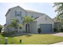 Charming two-story home featuring a well-manicured lawn and a two-car garage at 2183 Brillante Dr, St Cloud, FL 34771