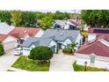 Aerial view of home featuring mature landscaping, a well-manicured lawn, and attached garage at 5813 Parkview Point Dr, Orlando, FL 32821