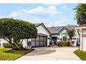 Charming single-story home featuring an attached garage, mature landscaping, and a well-manicured lawn at 5813 Parkview Point Dr, Orlando, FL 32821