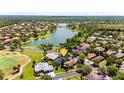 Breathtaking aerial shot of a residential community nestled around a serene lake and lush greenery, showcasing the neighborhood at 151 Bell Tower Xing W, Kissimmee, FL 34759