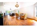 Bright and airy living space featuring wood floors, large windows, and comfortable seating, creating an inviting atmosphere at 151 Bell Tower Xing W, Kissimmee, FL 34759