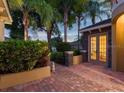 Paver courtyard featuring lush landscaping, brick accents, and double French doors leading to the interior at 2108 Northumbria Dr, Sanford, FL 32771