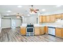 Modern kitchen features stainless steel appliances, light wood cabinetry, and a breakfast bar at 250 E 20Th Ave, Mount Dora, FL 32757