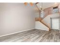 Spacious living room featuring soaring ceilings, a staircase, wood floors and plenty of natural light at 4060 E Maryland Pl, Casselberry, FL 32707