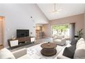 Inviting living room featuring vaulted ceilings, wood floors, and a seamless flow into the kitchen and backyard at 4060 E Maryland Pl, Casselberry, FL 32707