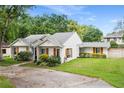 Single-story home featuring a charming exterior with beautiful landscaping at 407 Forest Rd, Mount Dora, FL 32757