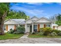 Quaint single-story house with a green front door and well-maintained landscaping at 407 Forest Rd, Mount Dora, FL 32757