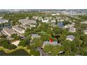 Aerial view of the condo complex surrounded by lush greenery and serene ponds at 5136 Park Central Dr # 212, Orlando, FL 32829