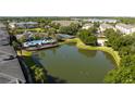 Scenic aerial view of the community pool, clubhouse, and tranquil pond at 5136 Park Central Dr # 212, Orlando, FL 32829