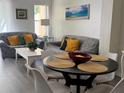 Cozy dining area featuring luxury vinyl plank flooring, modern furniture, and beach themed artwork at 1119 Park Ridge Cir, Kissimmee, FL 34746