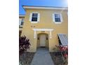 Inviting yellow home featuring white shutters and manicured landscaping creates a welcoming curb appeal at 1119 Park Ridge Cir, Kissimmee, FL 34746