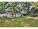 Large backyard with mature trees and well-maintained lawn, creating a serene outdoor space at 112 E Coleman Cir, Sanford, FL 32773
